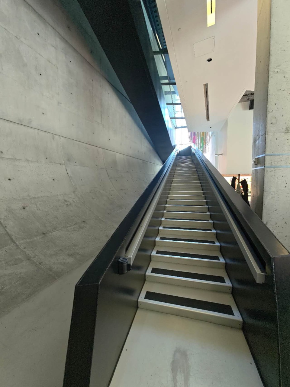 Interior stair rising between concrete walls at the Contemporary Arts Center.