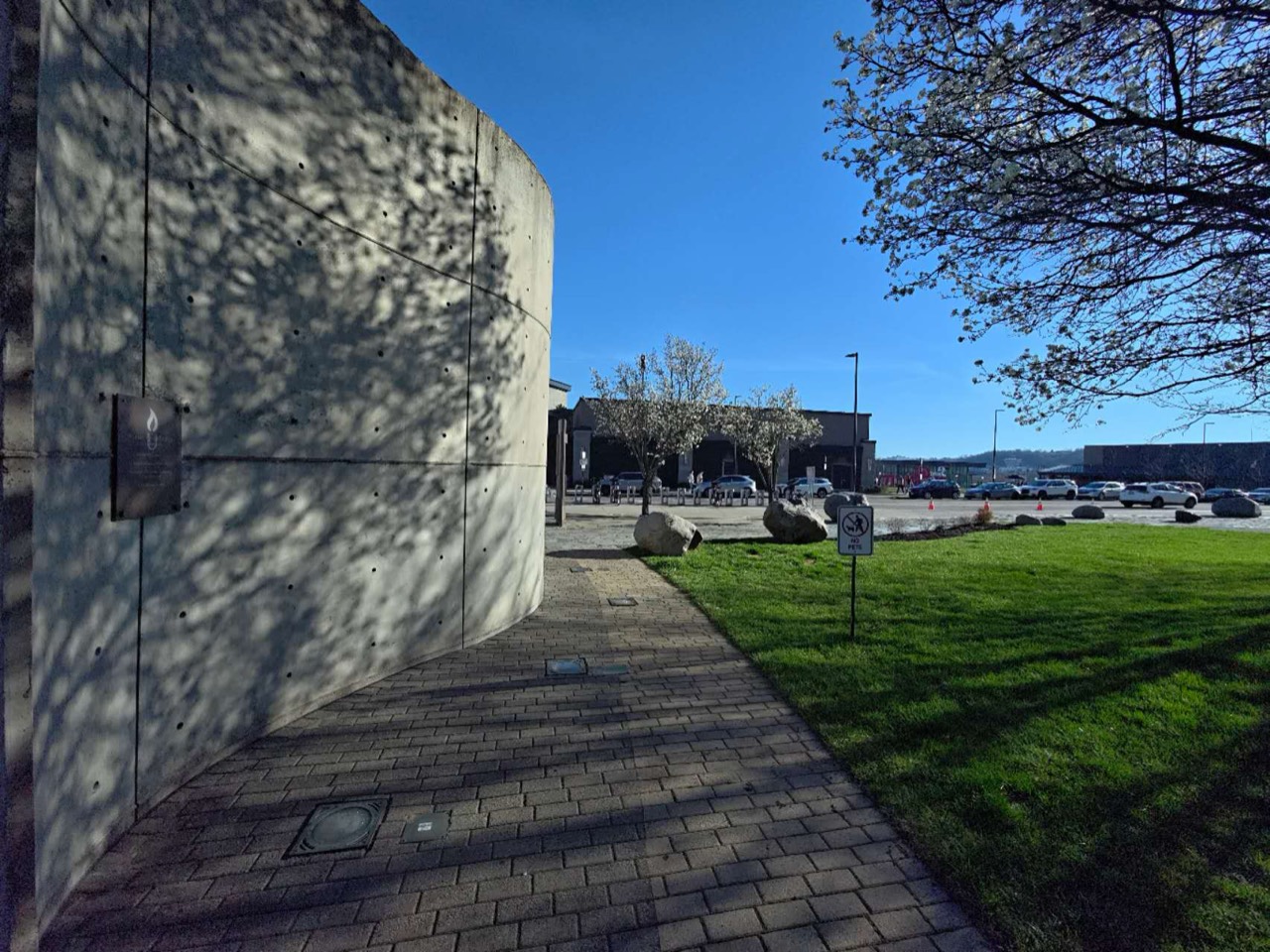 Curving concrete wall and tree shadows outside the National Underground Railroad Freedom Center.